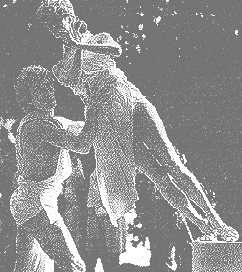 Living statue being mounted on a pedestal